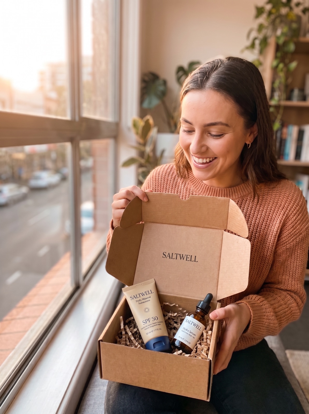 A skincare creator opening a box of products a brand sent her