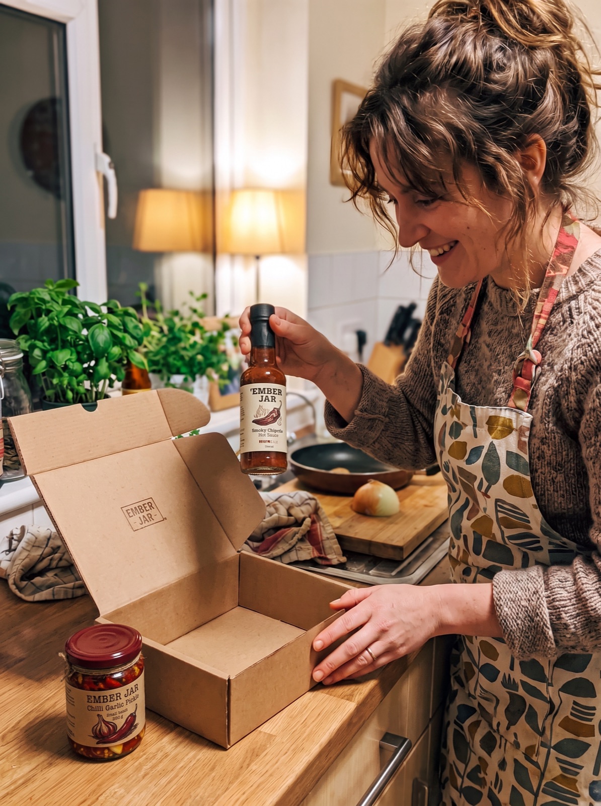 A home cook unboxing hot sauce and pickle a brand sent her